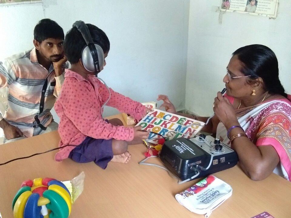 A child supported by a Bhavitha educator using learning equipment